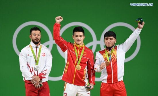 Shi Zhiyong of China (C), Daniyar Ismayilov of Turkey (L) and Izzat Artykov of Kyrgyzstan celebrate at the awarding ceremony of the men's 69KG weightlifting group A final at the 2016 Rio Olympic Games in Rio de Janeiro, Brazil, on Aug. 9, 2016. Shi Zhiyong won the gold medal with 352KG. (Xinhua/Cheng Min) Shi Zhiyong of China (C), Daniyar Ismayilov of Turkey (L) and Izzat Artykov of Kyrgyzstan celebrate at the awarding ceremony of the men's 69KG weightlifting group A final at the 2016 Rio Olympic Games in Rio de Janeiro, Brazil, on Aug. 9, 2016. Shi Zhiyong won the gold medal with 352KG. (Xinhua/Cheng Min)