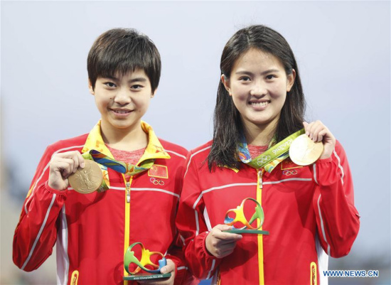 Chen Ruolin (R) and Liu Huixia of China attend the awarding ceremony of women's synchronised 10m platform diving at the 2016 Rio Olympic Games in Rio de Janeiro, Brazil, on Aug. 9, 2016. Chen Ruolin and Liu Huixia won the gold medal. (Xinhua/Fei Maohua) Chen Ruolin (R) and Liu Huixia of China attend the awarding ceremony of women's synchronised 10m platform diving at the 2016 Rio Olympic Games in Rio de Janeiro, Brazil, on Aug. 9, 2016. Chen Ruolin and Liu Huixia won the gold medal. (Xinhua/Fei Maohua)