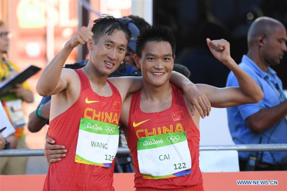 China's Wang Zhen (L) and his compatriot Cai Zelin celebrate after the men's 20km race walk of Athletics at the 2016 Rio Olympic Games in Rio de Janeiro, Brazil, on Aug. 12, 2016. Wang Zhen claimed the title with a time of 1:19:14. (Xinhua/Lui Siu Wai) China's Wang Zhen (L) and his compatriot Cai Zelin celebrate after the men's 20km race walk of Athletics at the 2016 Rio Olympic Games in Rio de Janeiro, Brazil, on Aug. 12, 2016. Wang Zhen claimed the title with a time of 1:19:14. (Xinhua/Lui Siu Wai)