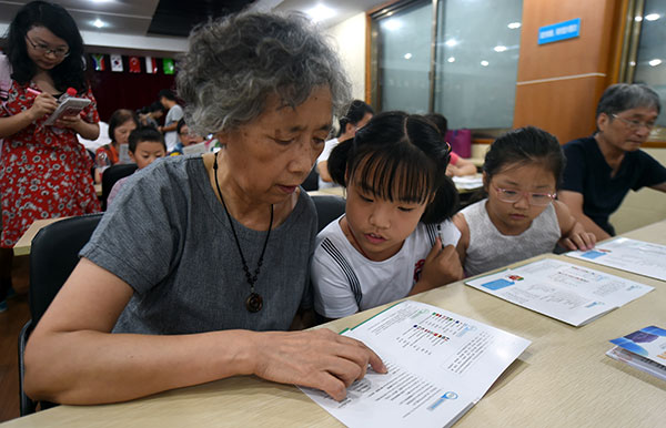 Lin Meiru, a 67-year-old resident of Hangzhou, studies English with her 12-year-old granddaughter Ling Jing at a community class in the city. Many of the locals are learning English to welcome the G20. Wang Dingchang / Xinhua Lin Meiru, a 67-year-old resident of Hangzhou, studies English with her 12-year-old granddaughter Ling Jing at a community class in the city. Many of the locals are learning English to welcome the G20. Wang Dingchang / Xinhua