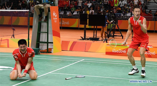 China's Zhang Nan (R) and Fu Haifeng celebrate after the men's doubles badminton gold medal match against Malaysia's Goh V Shem and Tan Wee Kiong at the 2016 Rio Olympic Games in Rio de Janeiro, Brazil, on Aug. 19, 2016. Zhang Nan and Fu Haifeng won the gold medal. (Xinhua/Lui Siu Wai) China's Zhang Nan (R) and Fu Haifeng celebrate after the men's doubles badminton gold medal match against Malaysia's Goh V Shem and Tan Wee Kiong at the 2016 Rio Olympic Games in Rio de Janeiro, Brazil, on Aug. 19, 2016. Zhang Nan and Fu Haifeng won the gold medal. (Xinhua/Lui Siu Wai)
