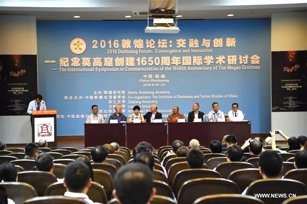 An international symposium in commemoration of the 1650th anniversary of the Mogao Grottoes is held in Dunhuang, northwest China's Gansu Province, Aug. 20, 2016. Over 150 experts and scholars attended the symposium Saturday. (Xinhua/Fan Peishen)