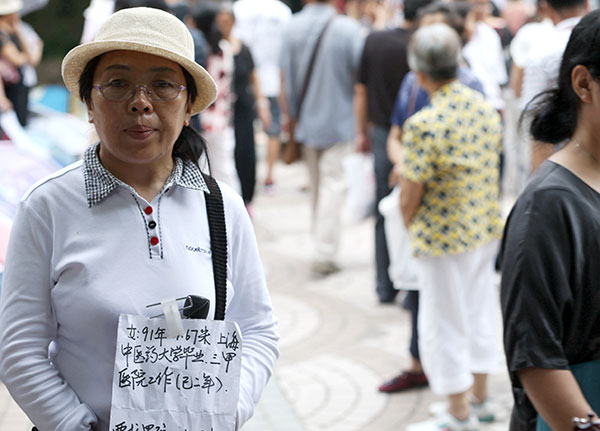 A woman holds a sheet of paper carrying information about her daughter at the park. (Photo by WANG YADONG/CHINA DAILY) A woman holds a sheet of paper carrying information about her daughter at the park. (Photo by WANG YADONG/CHINA DAILY)