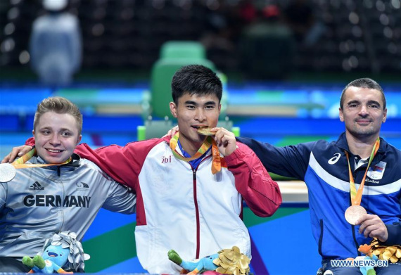 Cao Ningning (C) of China reacts during the medal presenting ceremony after Men's Singles Class 5 Gold Medal Match of Table Tennis against Valentin Baus of German at the 2016 Rio Paralympic Games in Rio de Janeiro, Brazil, Sept. 12, 2016. Cao Ningning won the Gold. (Photo: Xinhua/Zhu Zheng) Cao Ningning (C) of China reacts during the medal presenting ceremony after Men's Singles Class 5 Gold Medal Match of Table Tennis against Valentin Baus of German at the 2016 Rio Paralympic Games in Rio de Janeiro, Brazil, Sept. 12, 2016. Cao Ningning won the Gold. (Photo: Xinhua/Zhu Zheng)