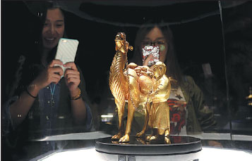 Visitors take photos on Monday of one of the relics of ancient civilizations along the Silk Road on display in Beijing's Badachu Park. Jiang Dong / China Daily Visitors take photos on Monday of one of the relics of ancient civilizations along the Silk Road on display in Beijing's Badachu Park. Jiang Dong / China Daily