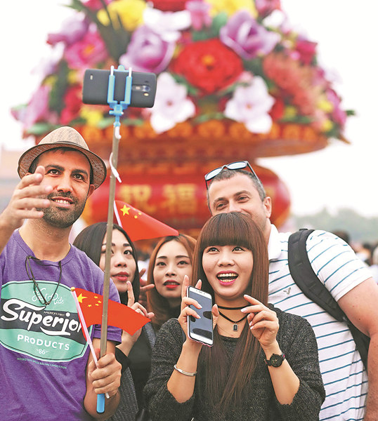 Visitors take selfie photos as crowds gather in Tian'anmen Square in Beijing on Saturday to celebrate National Day, marking the 67th anniversary of the founding of the People's Republic of China. Chen Xiaogen / for China Daily Visitors take selfie photos as crowds gather in Tian'anmen Square in Beijing on Saturday to celebrate National Day, marking the 67th anniversary of the founding of the People's Republic of China. Chen Xiaogen / for China Daily