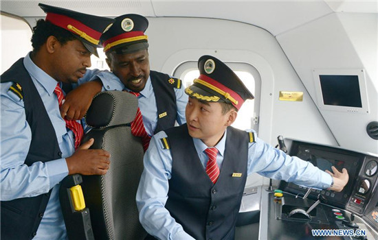 Chinese locomotive driver Liu Ji (R) trains his Ethiopian counterparts at a railway station in suburban Addis Ababa, Ethiopia, Oct. 1, 2016. A Chinese-built railway linking the Ethiopian capital and the port of Djibouti is expected to help the landlocked African country improve access to the sea and speed up a burgeoning industrialization process.(Xinhua/Sun Ruibo) Chinese locomotive driver Liu Ji (R) trains his Ethiopian counterparts at a railway station in suburban Addis Ababa, Ethiopia, Oct. 1, 2016. A Chinese-built railway linking the Ethiopian capital and the port of Djibouti is expected to help the landlocked African country improve access to the sea and speed up a burgeoning industrialization process.(Xinhua/Sun Ruibo)