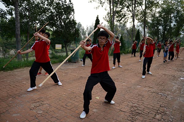 Children learn kung fu in a school of the Taguo Education Group in Dengfeng, Henan. (Photo by Xiang Mingchao/China Daily) Children learn kung fu in a school of the Taguo Education Group in Dengfeng, Henan. (Photo by Xiang Mingchao/China Daily)