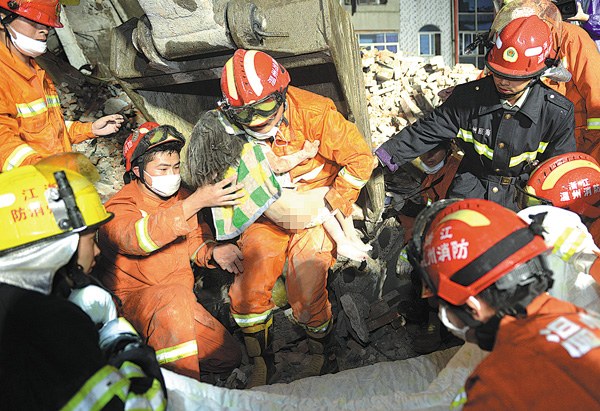 Firefighters rescue a 6-year-old girl from the rubble after four buildings collapsed in Wenzhou, Zhejiang province, on Monday. (Photo by YU GENLING/CHINA DAILY) Firefighters rescue a 6-year-old girl from the rubble after four buildings collapsed in Wenzhou, Zhejiang province, on Monday. (Photo by YU GENLING/CHINA DAILY)