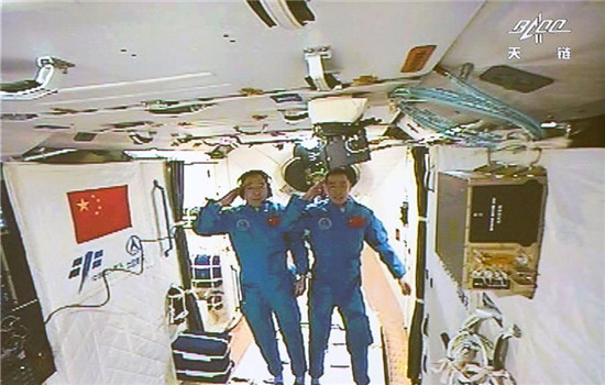 Photo taken on Oct. 19, 2016 shows the screen at the Beijing Aerospace Control Center showing the two Chinese astronauts Jing Haipeng (L) and Chen Dong saluting in the space lab Tiangong-2. (Xinhua/Ju Zhenhua) Photo taken on Oct. 19, 2016 shows the screen at the Beijing Aerospace Control Center showing the two Chinese astronauts Jing Haipeng (L) and Chen Dong saluting in the space lab Tiangong-2. (Xinhua/Ju Zhenhua)