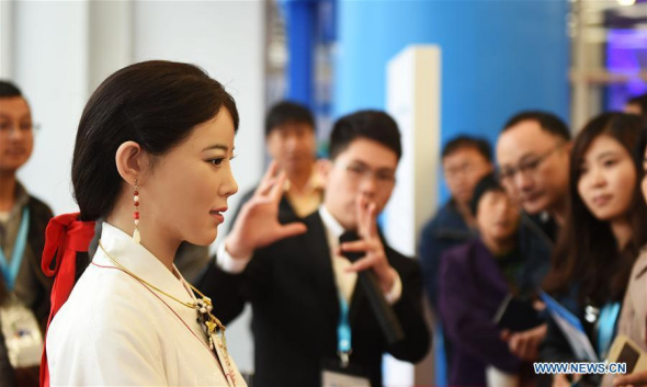 Visitors view an intelligent robot at the 2016 World Robot Exhibition in Beijing, capital of China, Oct. 21, 2016. The exhibition is held from Oct. 21 to 25 as part of the World Robot Conference. (Photo: Xinhua/Li Wen) Visitors view an intelligent robot at the 2016 World Robot Exhibition in Beijing, capital of China, Oct. 21, 2016. The exhibition is held from Oct. 21 to 25 as part of the World Robot Conference. (Photo: Xinhua/Li Wen)