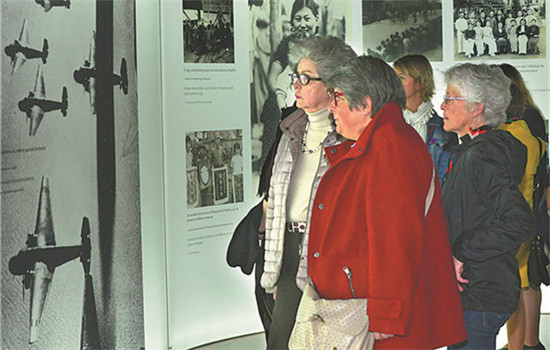 Visitors tour an exhibition about the Nanjing Massacre, in which 300,000 died in 1937, at the Memorial de Caen museum in France. (LONG JIANWU / CHINA NEWS AGENCY) Visitors tour an exhibition about the Nanjing Massacre, in which 300,000 died in 1937, at the Memorial de Caen museum in France. (LONG JIANWU / CHINA NEWS AGENCY)