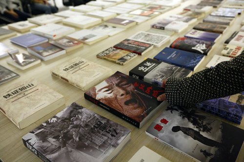 A visitor picks out a book on China's comfort women Saturday at a newly opened museum at Shanghai Normal University. A visitor picks out a book on China's comfort women Saturday at a newly opened museum at Shanghai Normal University.