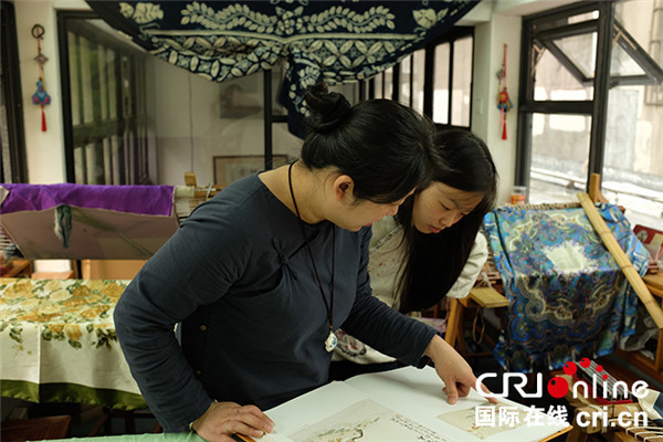File photo shows Jin Jiahong instructing a student on traditional Hangzhou embroidery in May 2015. (Photo/CRI Online) File photo shows Jin Jiahong instructing a student on traditional Hangzhou embroidery in May 2015. (Photo/CRI Online)