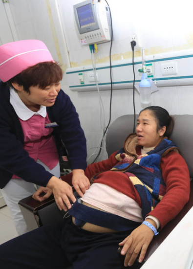 A nurse checks a pregnant woman at a hospital in Xiangyang, Hubei province, on Saturday. (GONG BO/ FOR CHINA DAILY) A nurse checks a pregnant woman at a hospital in Xiangyang, Hubei province, on Saturday. (GONG BO/ FOR CHINA DAILY)