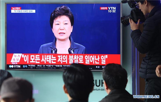People watch TV broadcasting South Korean President Park Geun-hye addressing the nation, at a train station in Seoul, South Korea, Nov. 4, 2016. South Korean President Park Geun-hye said Friday that she will accept an investigation into herself, if necessary, by prosecutors over a scandal surrounding Choi Soon-sil, the president's longtime confidante suspected of intervening into state affairs. (Xinhua/Yao Qilin) People watch TV broadcasting South Korean President Park Geun-hye addressing the nation, at a train station in Seoul, South Korea, Nov. 4, 2016. South Korean President Park Geun-hye said Friday that she will accept an investigation into herself, if necessary, by prosecutors over a scandal surrounding Choi Soon-sil, the president's longtime confidante suspected of intervening into state affairs. (Xinhua/Yao Qilin)