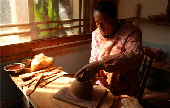 Tadrin Phuntsok is one of the best pottery makers in Nixi township, Yunnan province. His family has carried on the craftsmanship for generations. (WANG KAIHAO/CHINA DAILY) Tadrin Phuntsok is one of the best pottery makers in Nixi township, Yunnan province. His family has carried on the craftsmanship for generations. (WANG KAIHAO/CHINA DAILY)