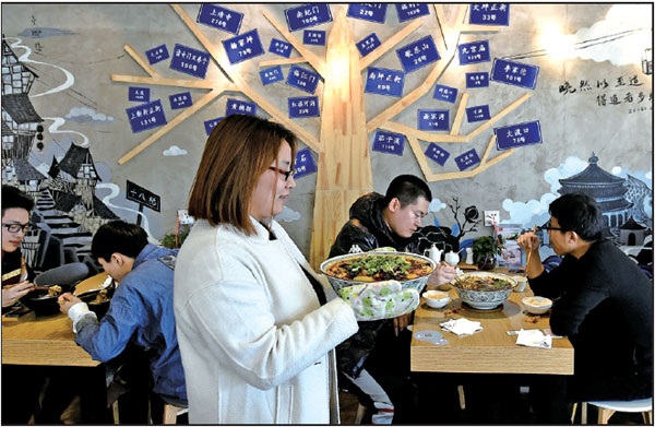 Zhang serves a dish to customers at her restaurant. Zhang serves a dish to customers at her restaurant.