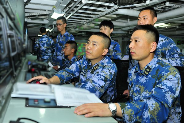 Huang Aijian (second from right), an officer with the electrical and mechanical squadron on the carrier, is on duty with his subordinates. (Photo/GT) Huang Aijian (second from right), an officer with the electrical and mechanical squadron on the carrier, is on duty with his subordinates. (Photo/GT)