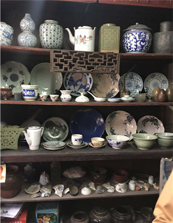 A cupboard filled with various types of china. A cupboard filled with various types of china.