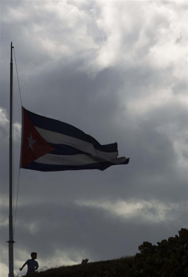 A boy stands below a Cuban national flag at half-mast in honor of Cuban revolutionary leader Fidel Castro, in Havana, capital of Cuba, on Nov. 27, 2016. (Photo: Xinhua/David de la Paz) A boy stands below a Cuban national flag at half-mast in honor of Cuban revolutionary leader Fidel Castro, in Havana, capital of Cuba, on Nov. 27, 2016. (Photo: Xinhua/David de la Paz)