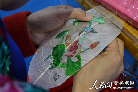 Ethnic Miao woman embroiders on leaves Ethnic Miao woman embroiders on leaves