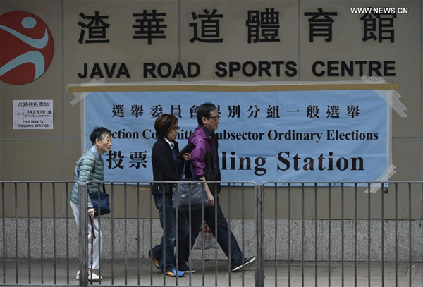 People walk near a polling station in Hong Kong, south China, Dec. 11, 2016. An election for the committee which is responsible for choosing the next Chief Executive of China's Hong Kong began on Sunday, during which more than 230,000 registered voters can cast their votes. (Xinhua/Wang Shen) People walk near a polling station in Hong Kong, south China, Dec. 11, 2016. An election for the committee which is responsible for choosing the next Chief Executive of China's Hong Kong began on Sunday, during which more than 230,000 registered voters can cast their votes. (Xinhua/Wang Shen)
