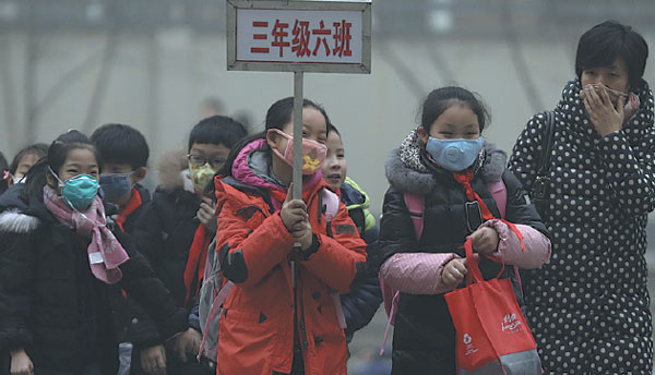 Primary school students wearing masks leave a school in Shijiazhuang, Hebei province, on Tuesday. The city, which had the worst air quality in November among 74 major cities monitored, ordered classes suspended on Wednesday. Zhu Xingxin / China Daily Primary school students wearing masks leave a school in Shijiazhuang, Hebei province, on Tuesday. The city, which had the worst air quality in November among 74 major cities monitored, ordered classes suspended on Wednesday. Zhu Xingxin / China Daily