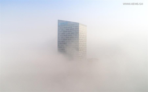 Photo taken on Jan. 3, 2017 shows a fog-bound building in Hefei, capital of east China's Anhui Province. A red alert for fog in large parts of China was issued by the National Meteorological Center on Tuesday. (Photo: Xinhua/Guo Chen) Photo taken on Jan. 3, 2017 shows a fog-bound building in Hefei, capital of east China's Anhui Province. A red alert for fog in large parts of China was issued by the National Meteorological Center on Tuesday. (Photo: Xinhua/Guo Chen)