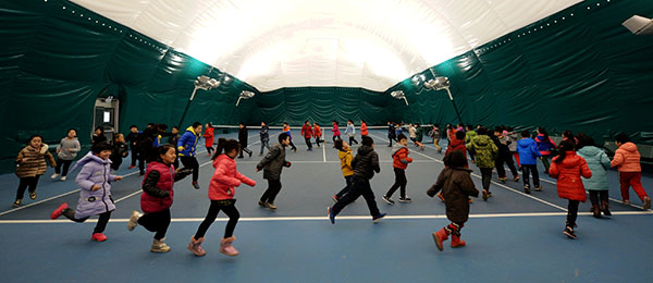 Students in a primary school in Shijiazhuang, capital of Hebei province, have their physical education class on Wednesday in a gym covered with an air cleaning system. (Photo by WANG XIAO/XINHUA) Students in a primary school in Shijiazhuang, capital of Hebei province, have their physical education class on Wednesday in a gym covered with an air cleaning system. (Photo by WANG XIAO/XINHUA)