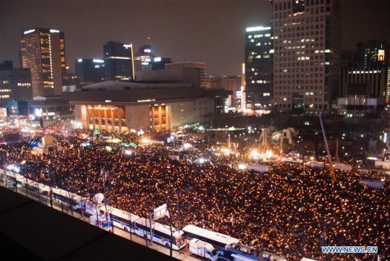 People attend a candlelight rally to demand President Park Geun-hye to step down in Seoul, South Korea, Dec. 31, 2016. (Xinhua/Lee Sang-ho) People attend a candlelight rally to demand President Park Geun-hye to step down in Seoul, South Korea, Dec. 31, 2016. (Xinhua/Lee Sang-ho)