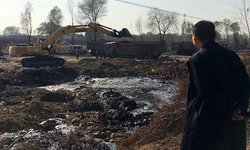 A man looks at the acid lake discovered between Jiaocheng and Wenshui counties in North China's Shanxi Province. (Photo/Courtesy of Cao Haidong) A man looks at the acid lake discovered between Jiaocheng and Wenshui counties in North China's Shanxi Province. (Photo/Courtesy of Cao Haidong)