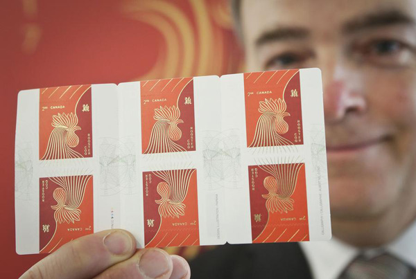 A staff member shows the rooster stamps in Vancouver, Canada, Jan 10, 2017. (Photo/Xinhua) A staff member shows the rooster stamps in Vancouver, Canada, Jan 10, 2017. (Photo/Xinhua)