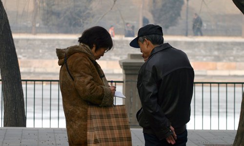Two parents swap their children's information in Zhongshan Park in central Beijing. Photo: Li Hao/GT Two parents swap their children's information in Zhongshan Park in central Beijing. Photo: Li Hao/GT