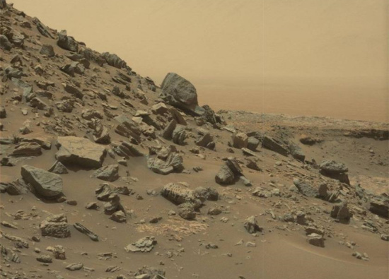 This image take by NASA's Curiosity Mars Rover shows a dramatic hillside outcrop with sandstone layers. This image take by NASA's Curiosity Mars Rover shows a dramatic hillside outcrop with sandstone layers.