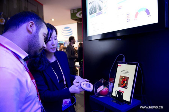 An employee works at her booth during the second day of the Mobile World Congress in Barcelona, Spain, on Feb. 28, 2017. (Xinhua/Lino De Vallier)