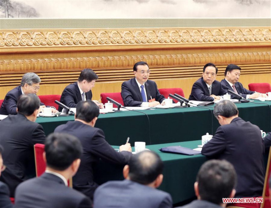 Chinese Premier Li Keqiang joins a panel discussion with deputies to the 12th National People's Congress (NPC) from Shandong Province at the annual session of the NPC in Beijing, capital of China, March 6, 2017. (Xinhua/Yao Dawei)