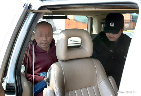 Police officers escort a fugitive into a vehicle at Pudong International Airport in east China's Shanghai, March 8, 2017. (Xinhua/Fan Jun) Police officers escort a fugitive into a vehicle at Pudong International Airport in east China's Shanghai, March 8, 2017. (Xinhua/Fan Jun)