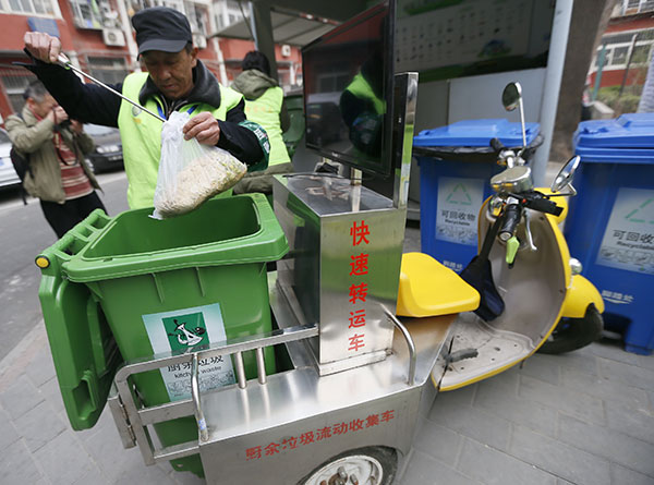 A sanitation worker collects kitchen waste in a residential area in Beijing's Chaoyang district on Wednesday.Cao Boyuan / For China Daily A sanitation worker collects kitchen waste in a residential area in Beijing's Chaoyang district on Wednesday.Cao Boyuan / For China Daily