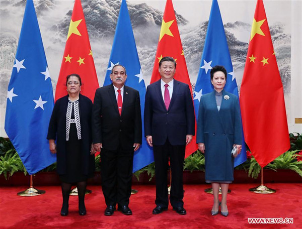Chinese President Xi Jinping (2nd R) and his wife Peng Liyuan pose for a photo with Micronesian President Peter M. Christian (2nd L) and his wife in Beijing, capital of China, March 27, 2017. Xi held a welcome ceremony for Micronesian President Peter M. Christian before their talks here on Monday. (Xinhua/Ju Peng) Chinese President Xi Jinping (2nd R) and his wife Peng Liyuan pose for a photo with Micronesian President Peter M. Christian (2nd L) and his wife in Beijing, capital of China, March 27, 2017. Xi held a welcome ceremony for Micronesian President Peter M. Christian before their talks here on Monday. (Xinhua/Ju Peng)
