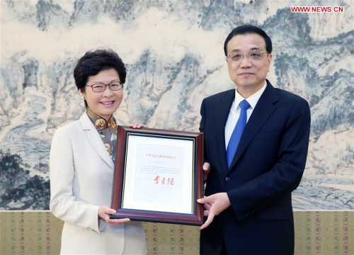 Chinese Premier Li Keqiang (R) grants the official certificate of appointment to Lam Cheng Yuet-ngor as the fifth-term chief executive of Hong Kong Special Administrative Region in Beijing, capital of China, April 11, 2017. (Xinhua/Yao Dawei) Chinese Premier Li Keqiang (R) grants the official certificate of appointment to Lam Cheng Yuet-ngor as the fifth-term chief executive of Hong Kong Special Administrative Region in Beijing, capital of China, April 11, 2017. (Xinhua/Yao Dawei)