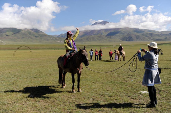 Tourists visit the Bayan Bulag grassland in Hejing County, northwest China's Xinjiang Uygur Autonomous Region, Aug. 12, 2016. (Xinhua/Wei Hai) Tourists visit the Bayan Bulag grassland in Hejing County, northwest China's Xinjiang Uygur Autonomous Region, Aug. 12, 2016. (Xinhua/Wei Hai)