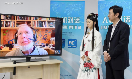 Chen Xiaoping (R), director of a robot research and development team, and Jia Jia, an interactive robot that looks like a real Chinese young woman in traditional outfit, talk through internet with Kevin Kelly on screen, founding executive editor of Wired magazine, in Hefei, capital of east China's Anhui Province, April 24, 2017. (Xinhua/Guo Chen) Chen Xiaoping (R), director of a robot research and development team, and Jia Jia, an interactive robot that looks like a real Chinese young woman in traditional outfit, talk through internet with Kevin Kelly on screen, founding executive editor of Wired magazine, in Hefei, capital of east China's Anhui Province, April 24, 2017. (Xinhua/Guo Chen)
