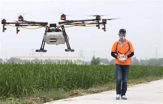 A worker uses a drone produced by drone maker DJI to spray pesticide on fields in Shanghai. (Photo/Xinhua) A worker uses a drone produced by drone maker DJI to spray pesticide on fields in Shanghai. (Photo/Xinhua)