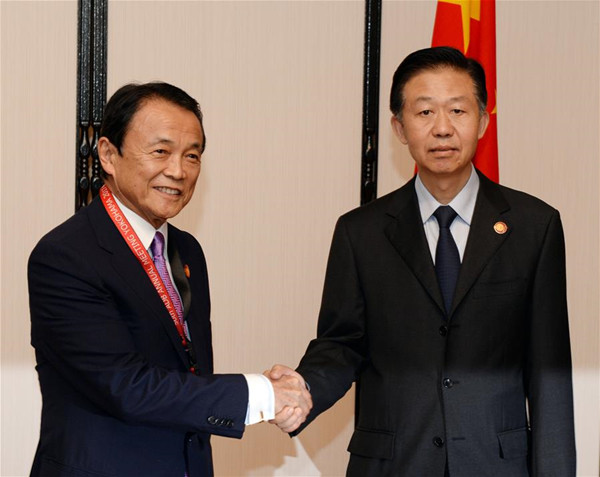 China's Finance Minister Xiao Jie (R) shakes hands with his Japanese counterpart Taro Aso during the sixth China-Japan bilateral finance dialogue in Yokohama, Japan, May 6, 2017. (Xinhua/Ma Ping) China's Finance Minister Xiao Jie (R) shakes hands with his Japanese counterpart Taro Aso during the sixth China-Japan bilateral finance dialogue in Yokohama, Japan, May 6, 2017. (Xinhua/Ma Ping)