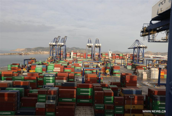 Photo taken on May 7, 2017 shows bridge cranes unloading goods from the merchant vessel (M.V.) COSCO Netherlands and loading goods to the vessel at Port of Piraeus, Greece.  (Xinhua/Yan Liang)