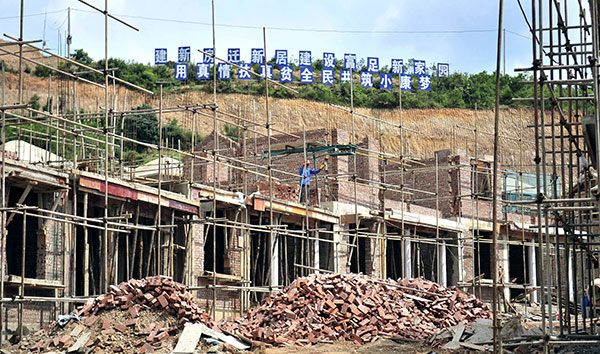 Workers build new houses for impoverished families in Xionglumo village, Yunnan province.(Liu Ranyang/China News Service) Workers build new houses for impoverished families in Xionglumo village, Yunnan province.(Liu Ranyang/China News Service)