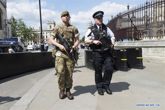 An armed soldier and an armed police officer patrol outside the Houses of Parliament in London, Britain, on May 24, 2017. British Prime Minister Theresa May announced Tuesday night that the country's terror threat level has been raised from severe to critical, its highest level. (Xinhua/Ray Tang) An armed soldier and an armed police officer patrol outside the Houses of Parliament in London, Britain, on May 24, 2017. British Prime Minister Theresa May announced Tuesday night that the country's terror threat level has been raised from severe to critical, its highest level. (Xinhua/Ray Tang)