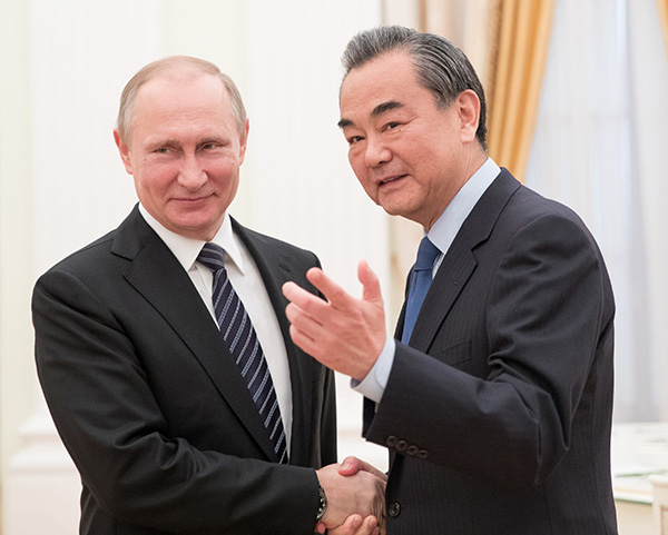 Russian President Vladimir Putin greets Foreign Minister Wang Yi during a meeting at the Kremlin in Moscow on Thursday. WU ZHUANG/XINHUA Russian President Vladimir Putin greets Foreign Minister Wang Yi during a meeting at the Kremlin in Moscow on Thursday. WU ZHUANG/XINHUA