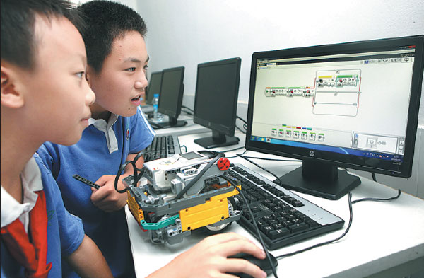Two students create a program for a Lego robot with a computer, at a primary school in Shenzhen. Zhao Yanxiong / For China Daily Two students create a program for a Lego robot with a computer, at a primary school in Shenzhen. Zhao Yanxiong / For China Daily